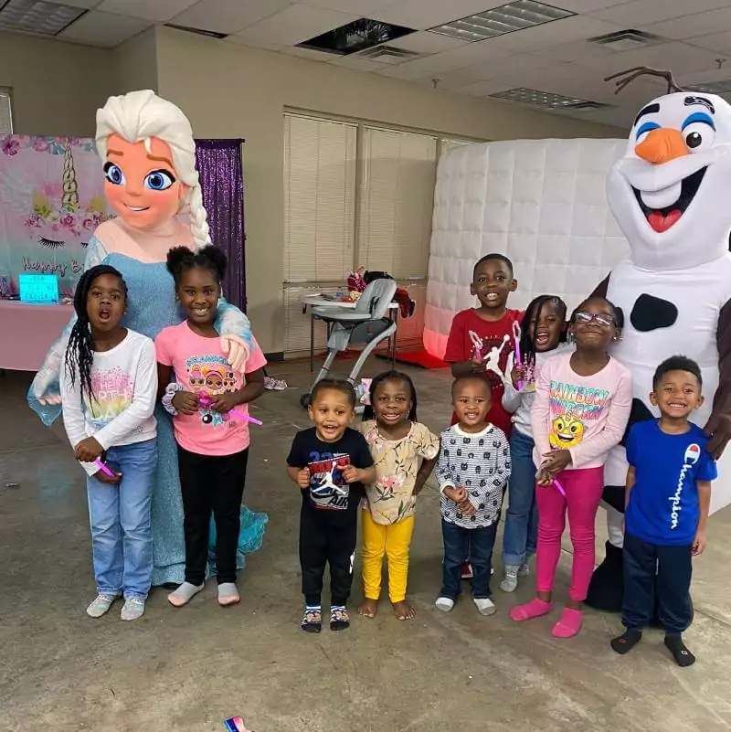 kids taking picture with elsa and mascott